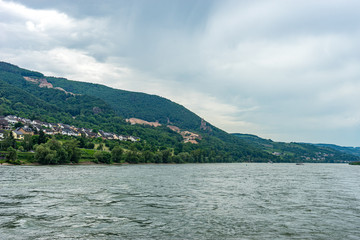 Fototapeta na wymiar Germany, Rhine Romantic Cruise, a large body of water with a mountain in the background