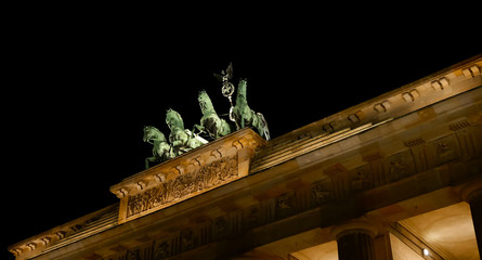 Brandenburg gate at night, Statue of the Goddess Victoria on chariot. Isolated on black background, Close up. Horses on Brandenburg Tor. Famous landmark. Viewed from the Pariser Platz. © Kost9