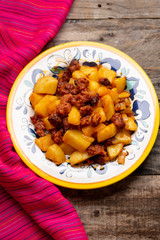 Mexican chorizo with potatoes on wooden background