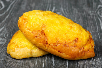 White bread loaf of wheat flour with cheese on a gray wooden background