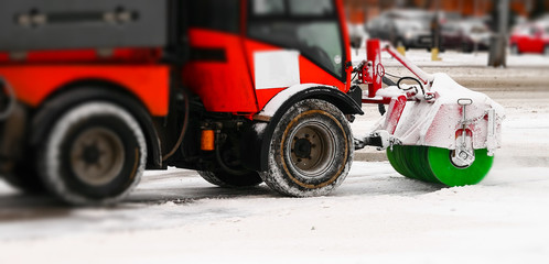 Snow machine cleans snow. Snow plow removing dirty and gray snow . Close-up. Spring or Autumn...
