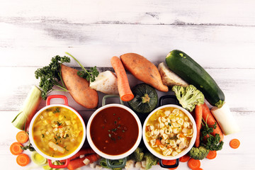 Set of soups from worldwide cuisines, healthy food. Broth with noodles, beef soup and broth with marrow dumplings. All soups with healthy vegetables on table