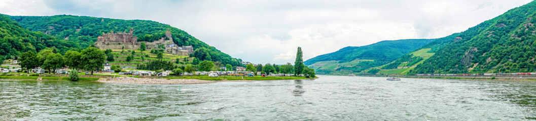 Fototapeta na wymiar Germany, Rhine Romantic Cruise, a large body of water with a mountain in the background panorama