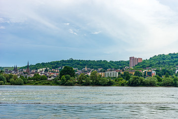 Fototapeta premium Germany, Rhine Romantic Cruise, a body of water with a city in the background