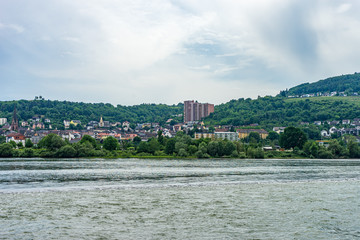 Fototapeta premium Germany, Rhine Romantic Cruise, a body of water with a city in the background