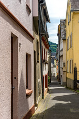 Germany, Rhine Romantic Cruise, Golden Lane, a person walking down a sidewalk in front of a brick building with Golden Lane in the background