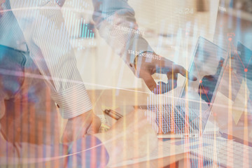 Double exposure of graph with man typing on computer in office on background. Concept of hard work. Closeup.