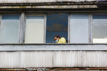Quarantined girl in medical mask at home