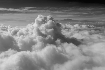Obraz premium Flying above the clouds overlooking mount Kilimanjaro, Tanzania. Black and white