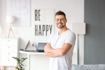 Handsome man wearing glasses at home