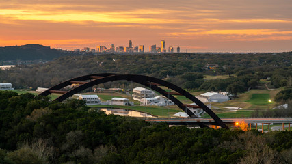 View of the Austin Skyscrappers With Sunrise Color Reflected on them from the 360 Bridge