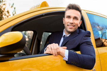 Handsome man driving taxi car