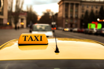 Modern taxi car on city road, closeup