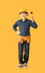 Cute little builder on color background