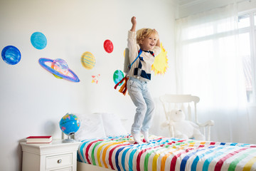 Kids play astronaut. Space and planet child game.