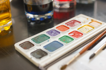 glasses with multicolored coloring water ant paints. close-up. Easter preparations.