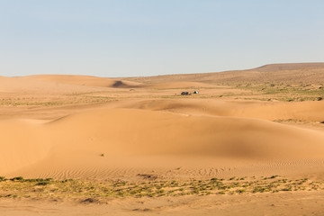Fototapeta na wymiar Mongolia Gobi desert, minibus and tourist tent in Khongor sand dunes