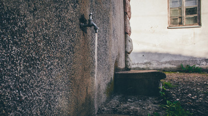 Water flows out of the old faucet in a Serbian village.