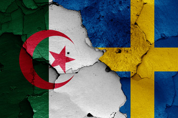 flags of Algeria and Sweden painted on cracked wall