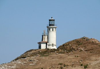 Fototapeta na wymiar Lighthouse on East Anacapa Island in Channel Islands National Park, California on sunny summer afternoon.