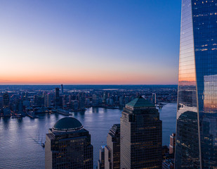 Aerial view of New York city and one world trade center brookfield place at dusk.