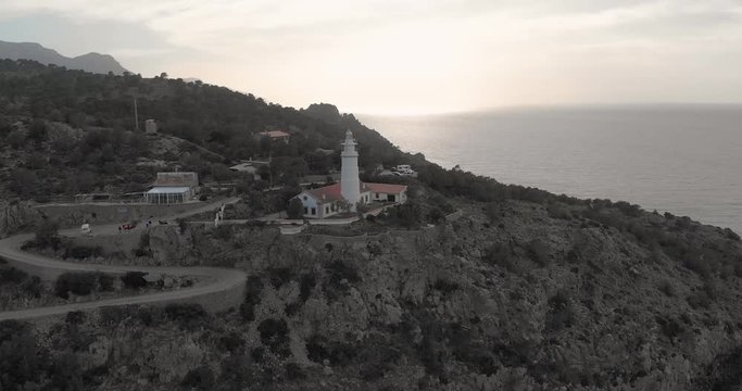 Aerial, drone shot of the Far des Cap Gros lighthouse, near Port de Soller, at sunset, in Mallorca, Spain 