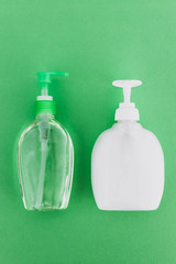 keep clean to fight bacteria and viruses, hand sanitizer and liquid soap and green background