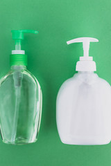 keep clean to fight bacteria and viruses, hand sanitizer and liquid soap and green background
