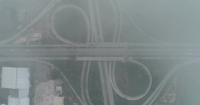 Aerial view of Mist flows through road  traffic during at day.