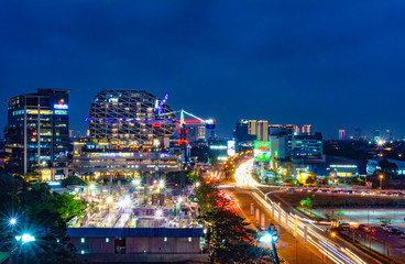 Naklejka premium Tangerang, Indonesia - 26th Sept 2019: The scenery at Gading Serpong Boulevard at night. Long exposure photo with light trails. Gading Serpong is a luxury real estate with high property investment.