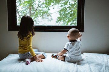 cute little brother and sister interaction on the bed