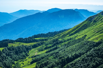 Fototapeta premium View over the Green Valley, surrounded by high mountains on a clear summer day