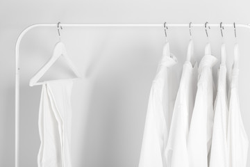 White clothes hanging on a rack