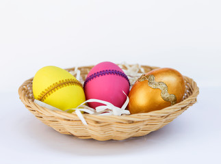 Colorful Easter egg in round basket, Easter holiday concept