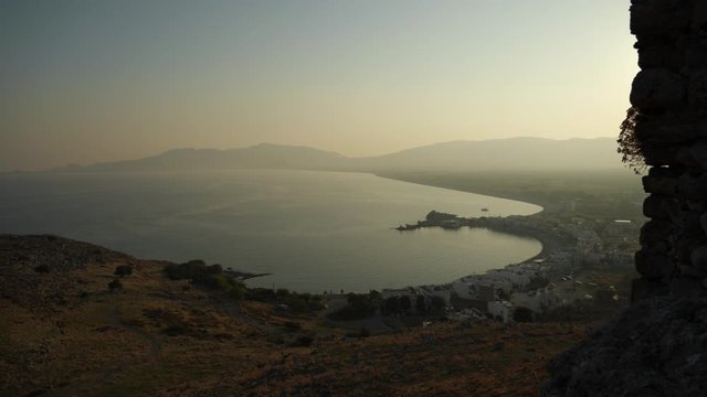 Aerial view of Charaki village in shade of Feraklos Castle on the hill at sunset, Rhodes, Greece