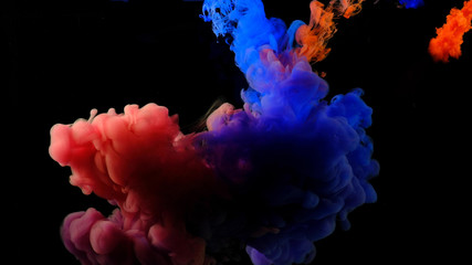 Obraz premium Color drops in water , abstract color mix , drop of Ink color mix paint falling on water Colorful ink in water, 
