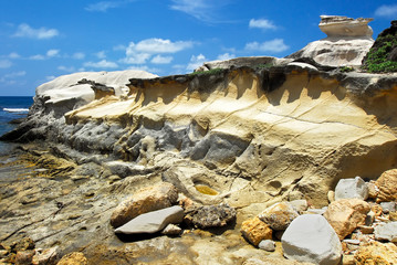 Scenic low-angle view of Capurpuraoan Rocks, also Kapurpurawan Rock Formation at the coast near Burgos, Ilocos Norte, North Luzon, Philippines, Asia