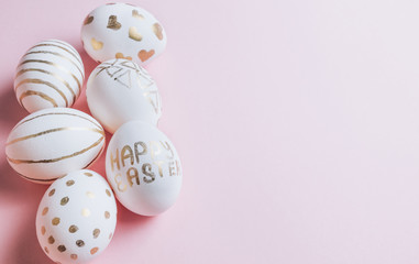 Easter eggs are hand-drawn on pink pastel background. Selective focus. Space for text. Minimalism and Happy Easter concept.