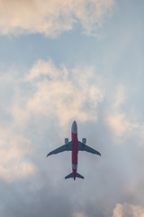 Beautiful images of white and red planes flying in the sky with a cloudy, gloomy backdrop like rainstorms that just passed.