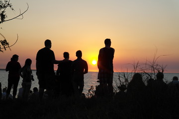 Fototapeta premium Silhouette of people on beach at Sunrise or Sunset.