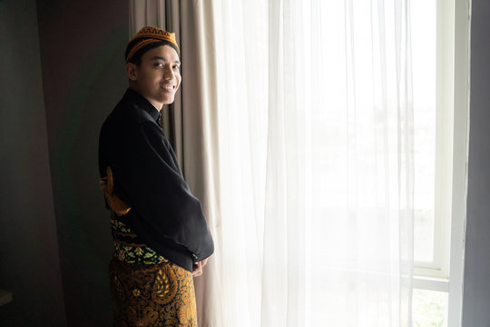 Young asian man wearing traditional clothes,beskap is traditional heritage clothes from Java,Indonesia