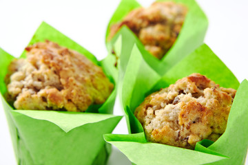 Three Muffins or Cupcakes in Green Paper Isolated