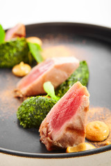 Tuna fillet with stewed spinach close up view