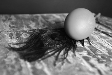 black and white Easter egg near a beautiful feather