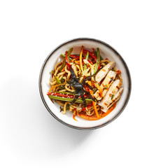 Wok udon with vegetables and chicken top view