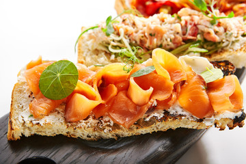 Delicious snacks with chorizo, burrata and baked tomatoes