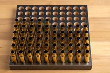 Production of cartridges for a rifle, reload. Many empty shells in the stand, top view