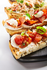 Bruschetta with baked tomatoes closeup view