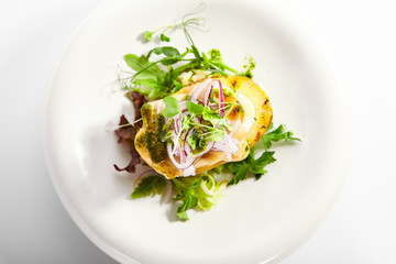 Baked potato with egg and pickled onion