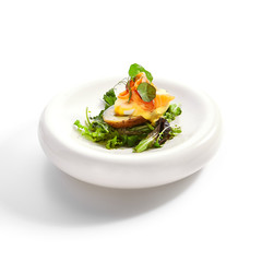 Baked potato with egg and salmon closeup view